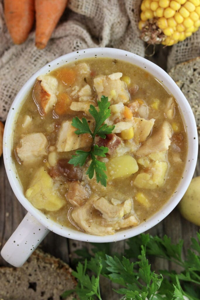 A bowl of chicken of the woods soup cooked like minestra with fresh bread and vegetables.